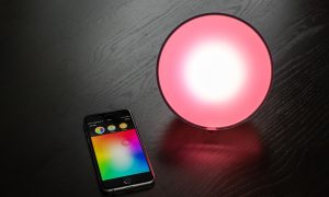 RGB smart lamp and phone on table